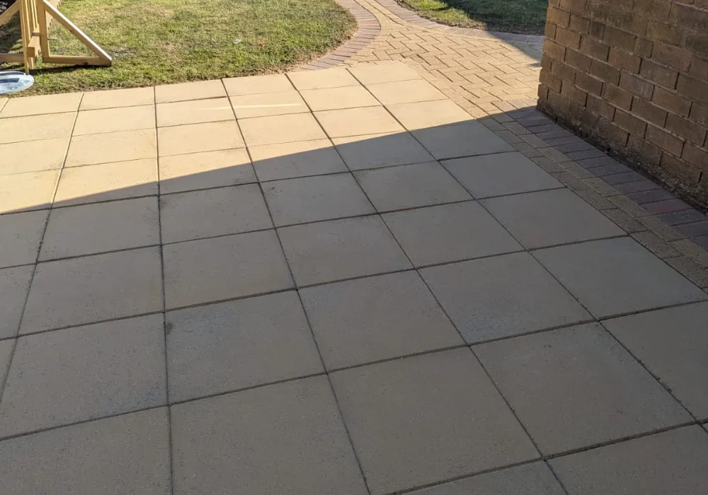 Patio partly cleaned, showing the before and after difference