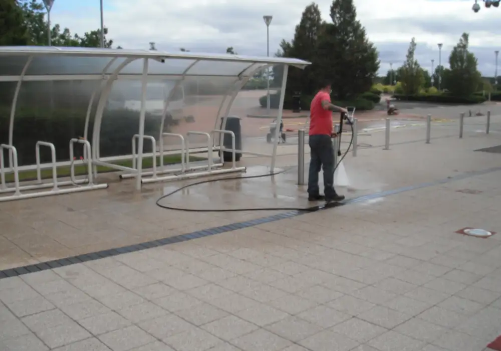 Pressure washing the paving around a cycle shelter