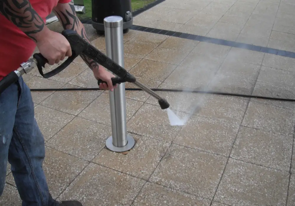 Pressure washing paving slabs around a bollard