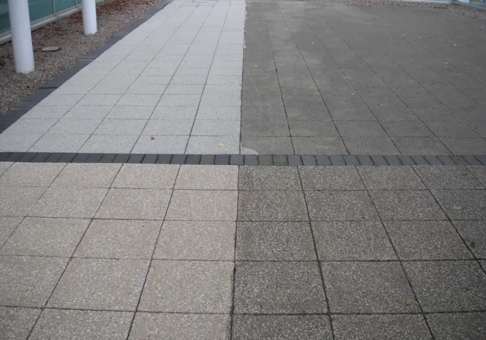 Commercial paving half cleaned, showing the before and after difference