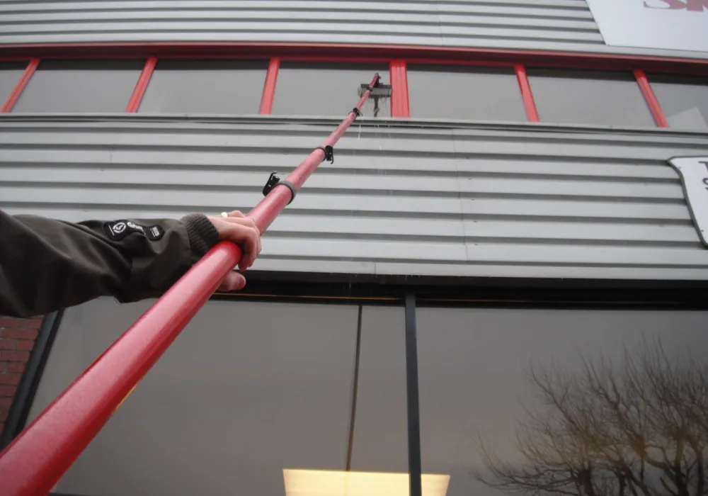 Water-fed pole reaching the high windows of a commercial unit