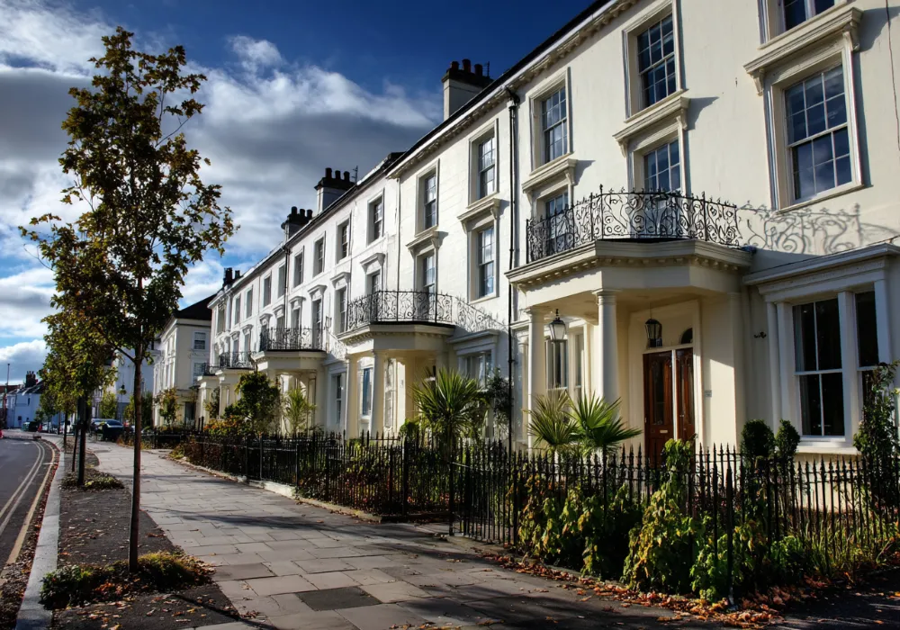 Terrace of cream rendered townhouses with iron balconies