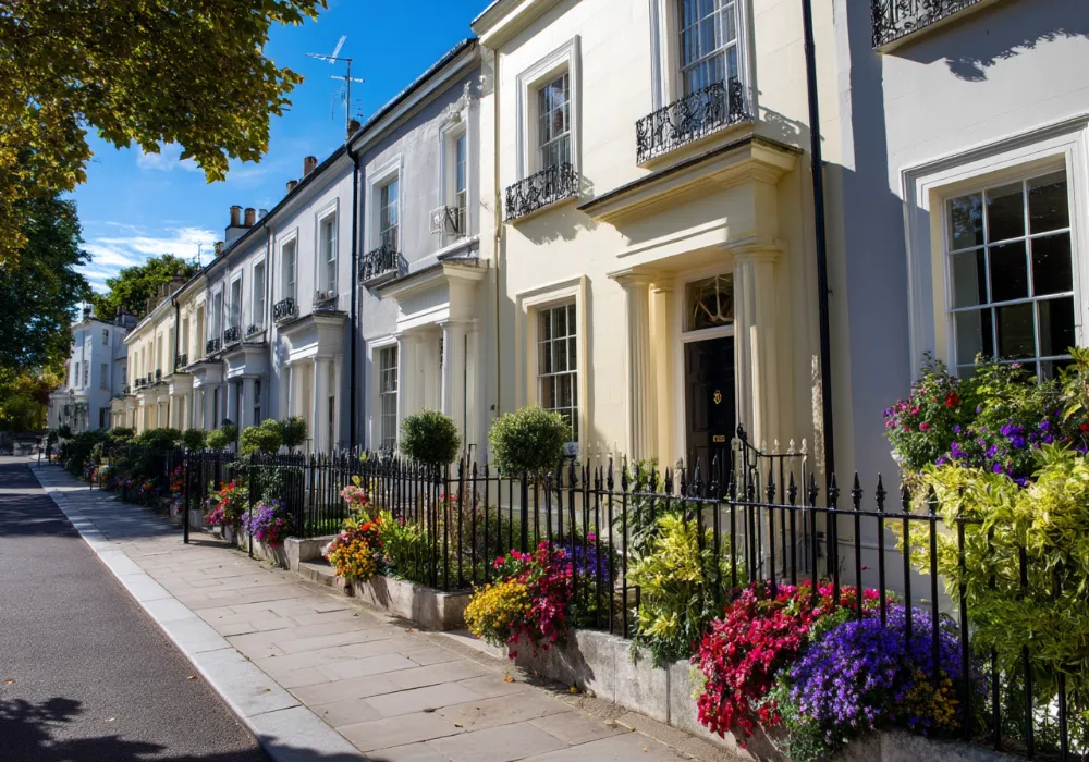 Terrace of houses with clean white render and front gardens