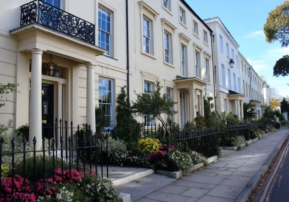 Townhouse entrance with columns and clean cream render