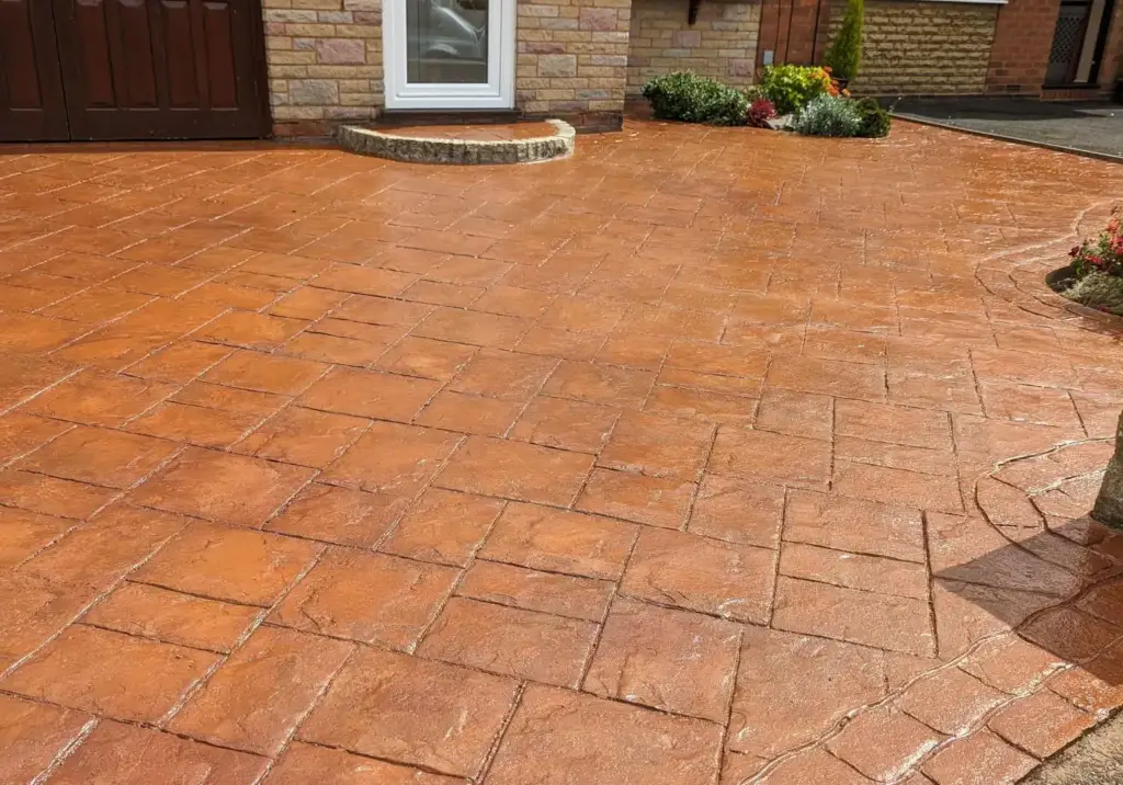 The same imprinted concrete by the front door step after cleaning and resealing